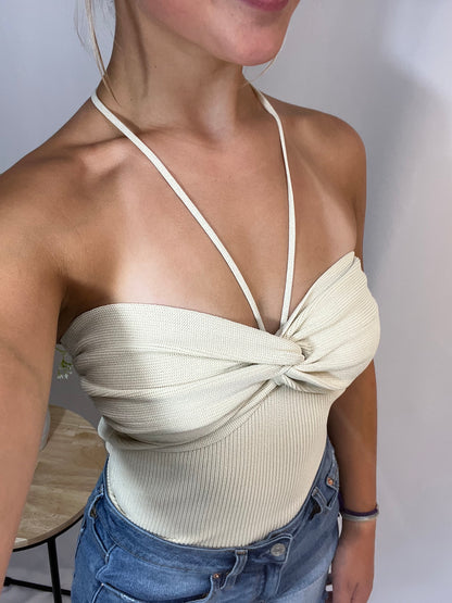 Close-up of crossed knit top, women’s soft breathable sweater with criss‑cross front detail