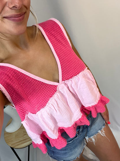 Close-up of bright pink and baby pink ruffle sleeveless thermal babydoll tank, women’s cropped waffle knit top with flowy fit
