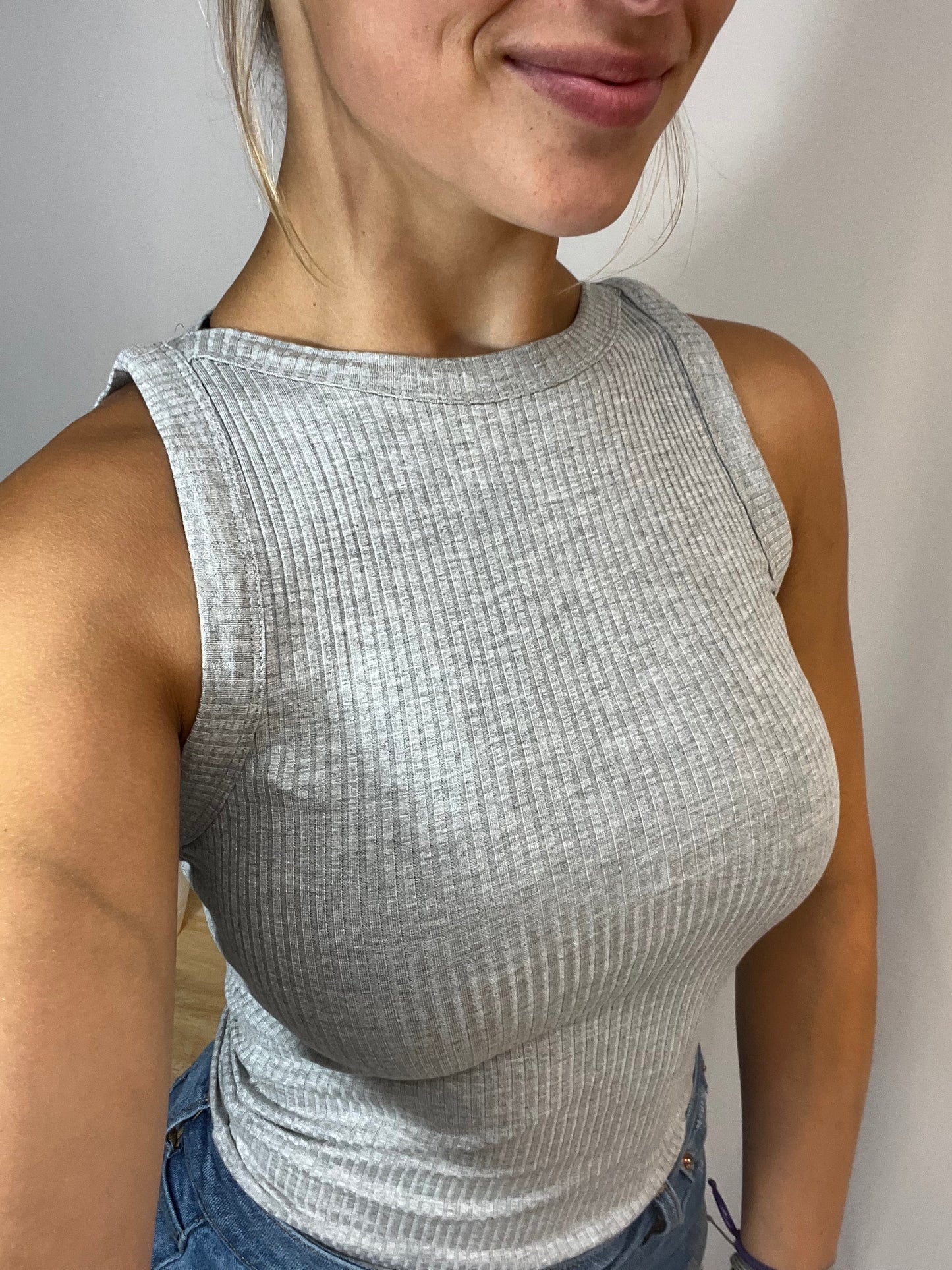 Close-up of soft ribbed high neck tank, women’s ribbed knit sleeveless high neckline top
