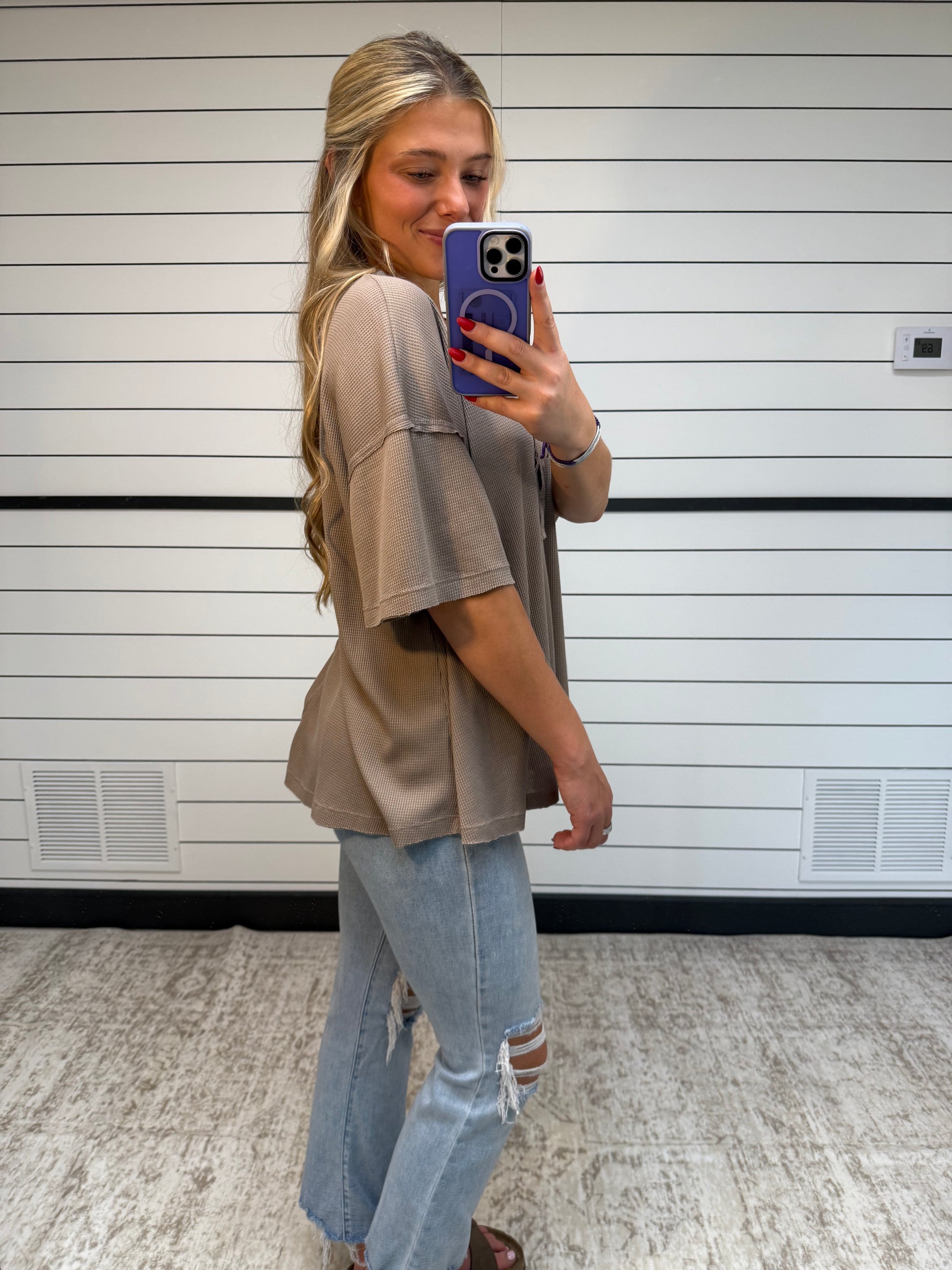 Side view of soft plume henley top, women’s relaxed knit shirt with button placket and long sleeves