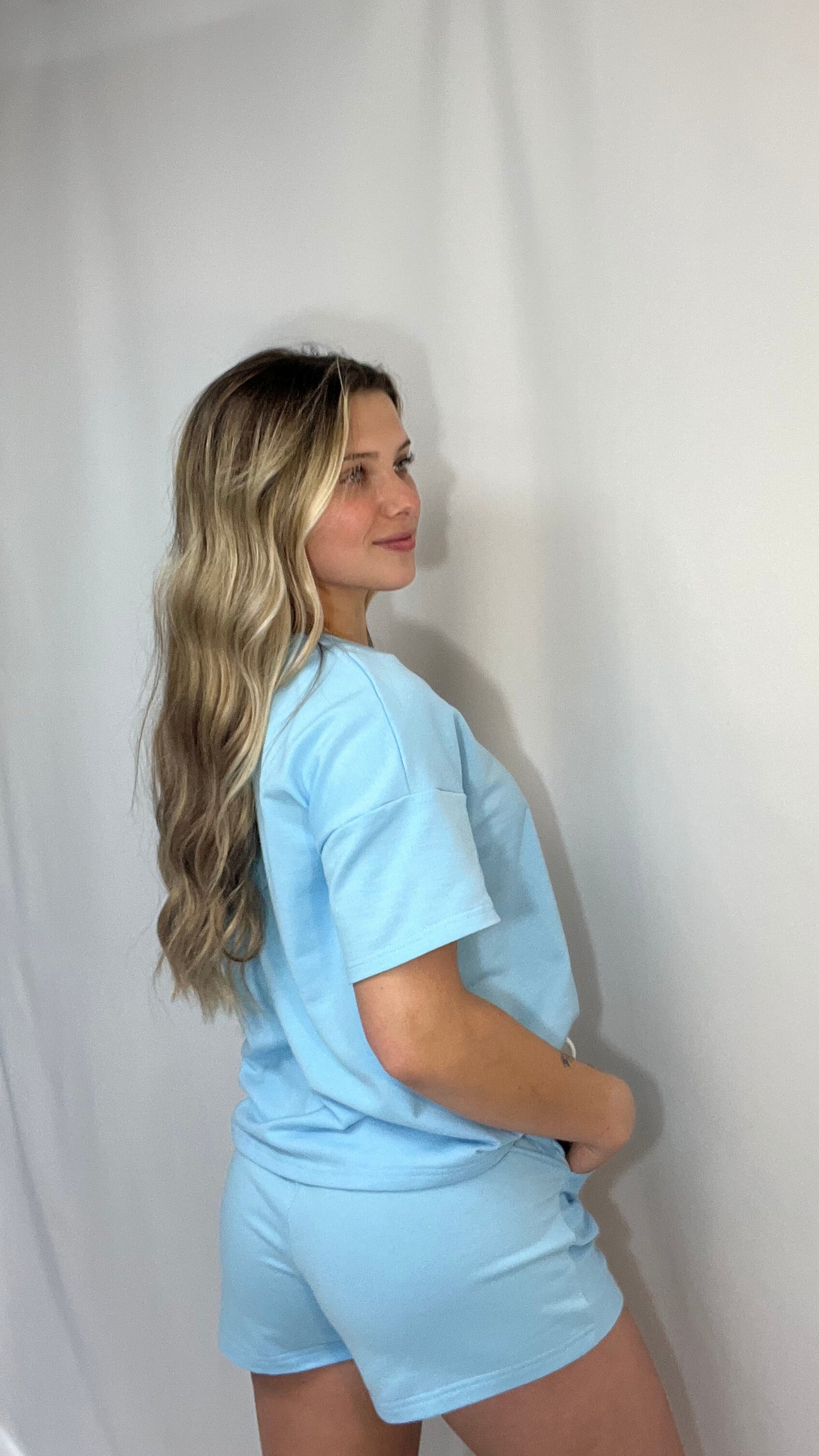 Back view of women’s v-neck tee and matching shorts set, soft jersey loungewear outfit