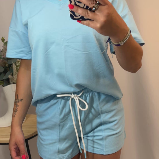 Close-up of women’s v-neck tee and matching shorts set, soft jersey loungewear outfit