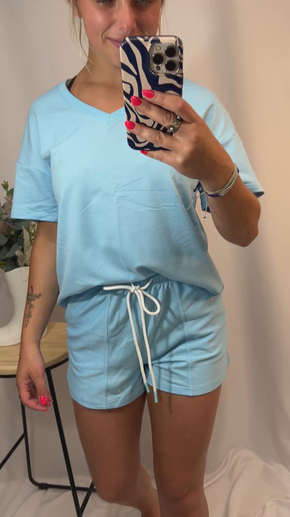 Close-up of women’s v-neck tee and matching shorts set, soft jersey loungewear outfit